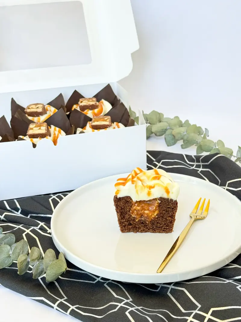 Chocolate cupcakes with caramel and peanut in the box Active Image