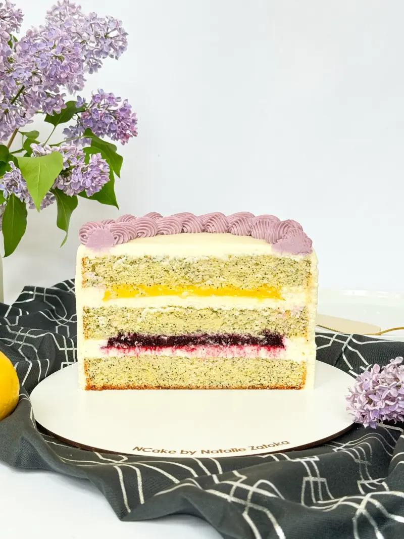 half of poppy lemon cake on the cake board Active Image